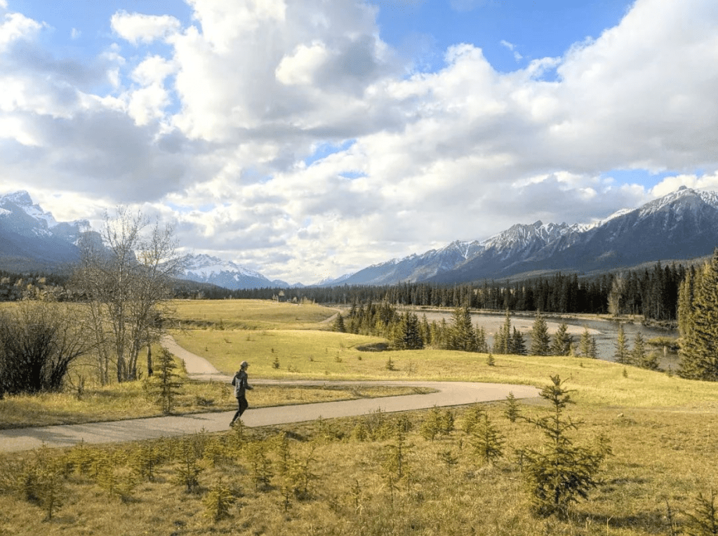 Woman running on path in scenic Canmore, Alberta